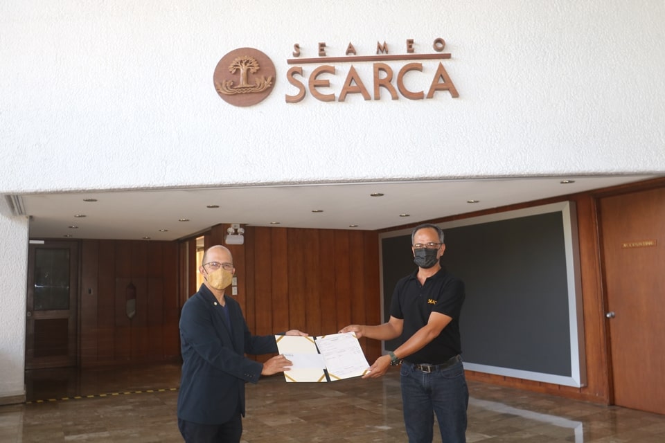 Mr. Gaspar L. de Chavez, Recipient of the 2020/2021 SEAMEO Service Award, receives his cash prize from Dr. Glenn B. Gregorio, SEARCA Director.