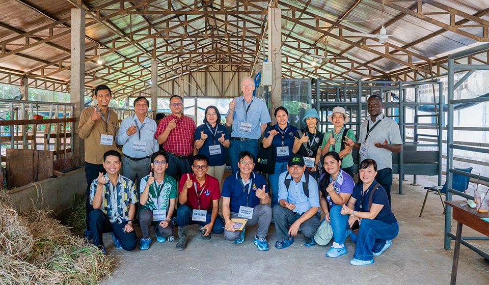 Participants and organizers pose in front of the Headbox Facility in RUA, Cambodia.