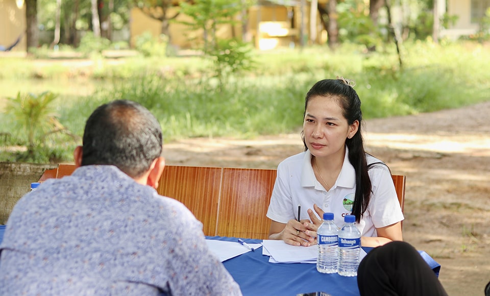 An enumerator from CE SAIN interviews a mother at Raksmey Sophanna High School in Kampong Thom, Cambodia.