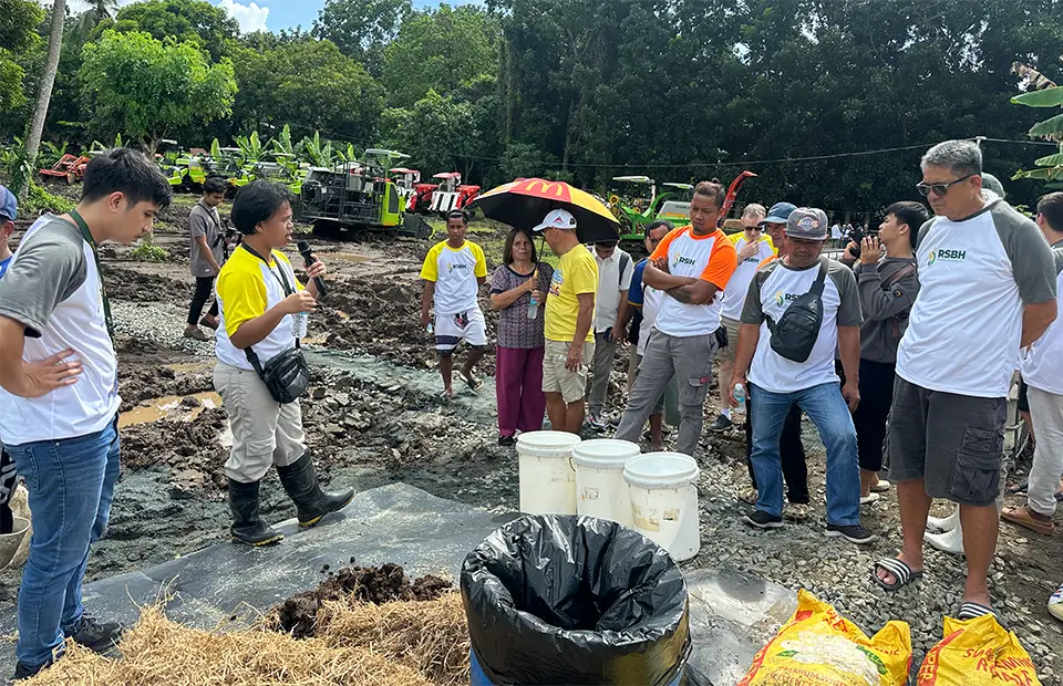 Engr. Joshua Morato explains how the biogas setup works using rice straw as feedstock.