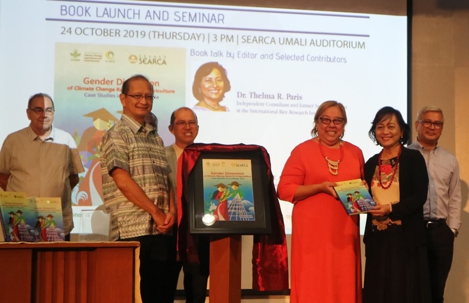 Dr. Thelma R. Paris (right), the lead book editor, hands a copy to Dr. Nina Castillo-Carandang, the youngest daughter of the late Dr. Gelia T. Castillo, to whom the book was dedicated, as (from left) Dr. Reiner Wassman, one of the writer-contributors of the book; Dr. Glenn B. Gregorio, SEARCA Director; Dr. Leocadio S. Sebastian, CCAFS SEA Program Leader; and Mr. Gary Carandang look on.