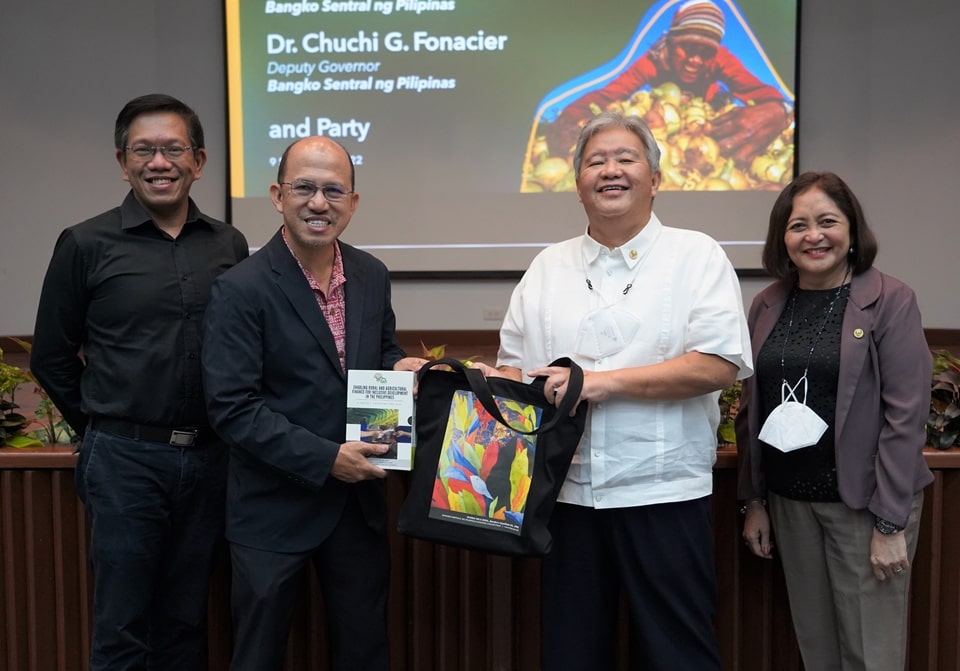 Dr. Glenn B. Gregorio (second from left), SEARCA Director, receives a book titled "Enabling Rural and Agricultural Finance for Inclusive Development in the Philippines" from Dr. V. Bruce J. Tolentino, Bangko Sentral ng Pilipinas (BSP) Monetary Board Member. Authored by Dr. Tolentino, the book is a three-volume compilation of papers, reports, and policy notes on promotion of effective and efficient financial services in support of inclusive rural and agricultural development. Also in the photo are Assoc. Prof. Joselito G. Florendo (leftmost), SEARCA Deputy Director for Administration, and Dr. Chuchi G. Fonacier (rightmost), BSP Deputy Governor.