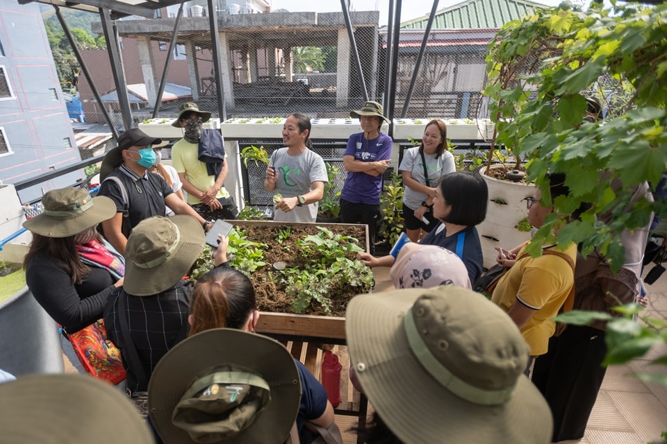 Mr. Al Linsangan (middle), founder of Coron Natural Farms, demonstrates the sustainable farming technologies in the Green Roof Garden.