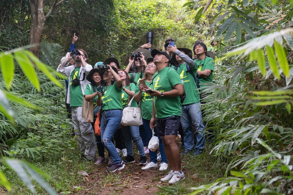 Conference participants birdwatch during the mobile workshop at Kingfisher Park.