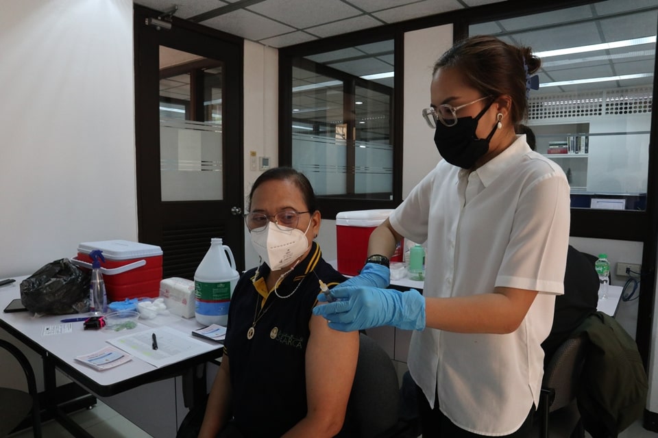 A medical doctor vaccinates one of the recipients with an Influenza shot during the Pneumonia and Influenza Vaccination Program.