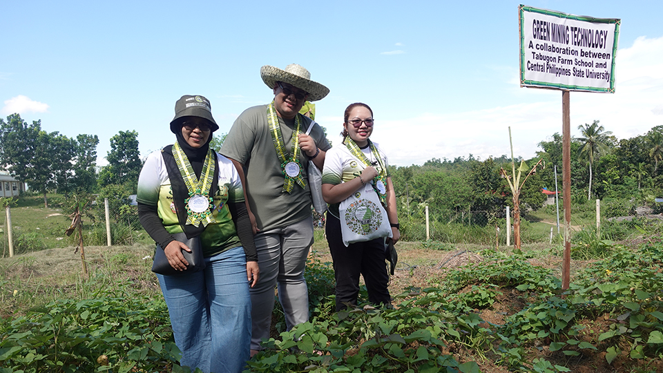 Dr. Nur, Mr. Barradas, and Ms. Medina get an up-close look at the green mining technology piles at Tabugon Farm School.