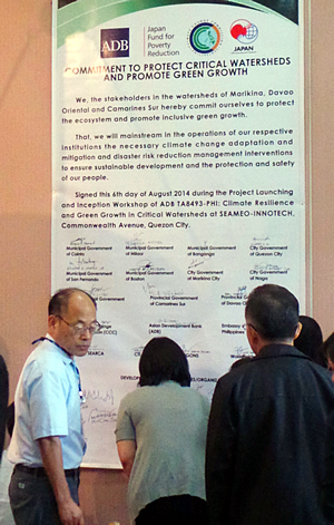 Mr. Nabuo Sato (leftmost), Chief Adviser and Specialist on Weather Forecasting and Weather Administration of the Philippine Atmospheric, Geophysical and Astronomical Services Administration (PAGASA), awaits his turn to sign the commitment document.