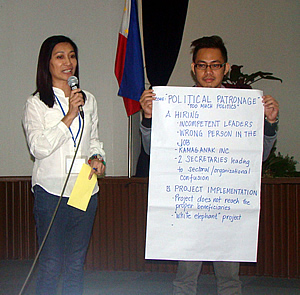 Participants engaged in role playing to identify  some of the issues that served as hindrance to social accountability in the agricultural sector. In photo are Ms. Mildred M. Buazon, OIC - Administrative Division, Bureau of Fisheries and Aquatic Resources (BFAR) (left), and Dr. Ronan G. Zagado, Supervising Science Research Specialist, Philippine Rice Research Institute (PHILRICE) (right).