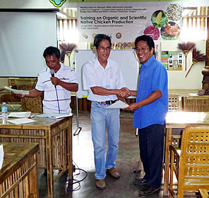 A participant receiving his certificate of completion from Dr. Arsenio D. Calub, Project Leader.