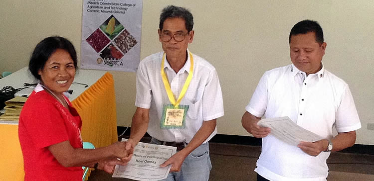 A participant receives her certificate from Dr. Arsenio D. Calub, Project Leader, and Dr. Rosalito A. Quirino, MOSCAT President.