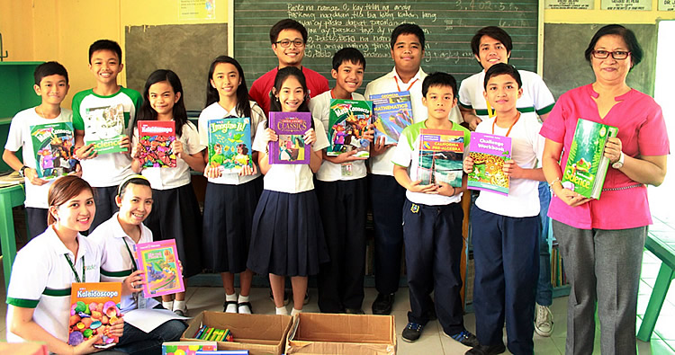 Elementary students receive science, mathematics, and language textbooks and reference materials from SEARCA.