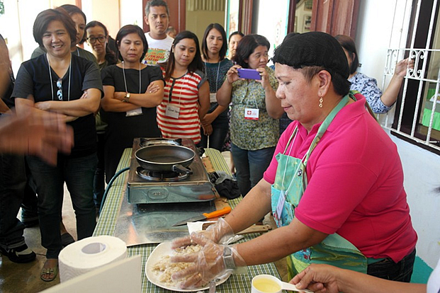 Mrs. Morales demonstrates how to cook the inner core of banana.