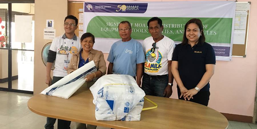 L-R: Mr. Zadieshar Sanchez, Administrative Officer V, PCC National Headquarters; Dir. Gloria Dela Cruz, PCC Center Director at DMMMSU; Mr. Romeo S. Doton, Chairman; Mr. Nicasio E. Olipas, Jr., Vice Chairman of PPMPC; and Ms. Nancy Landicho, SEARCA Program Specialist during the awarding of supplies of 2,000 pieces of plastic bags for their forage silage.