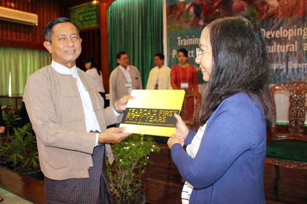 Dr. Tin Htut receives the coffee table book SEARCA's First Fifty Years from Dr. Cadiz.