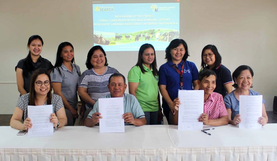 Board Members of RODRA and GENTRI, together with PCC and SEARCA Officials and Staff, posed for a photo with the signed MOA for the project, Forage Conservation and Milk-Handling Support for Resilient Carabao-Based Dairy Enterprise in Region IV- A, on 13 February 2018 at SEARCA Residence Hotel.